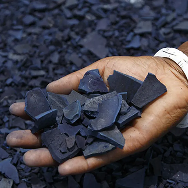 Cakes of natural indigo dye in a hand